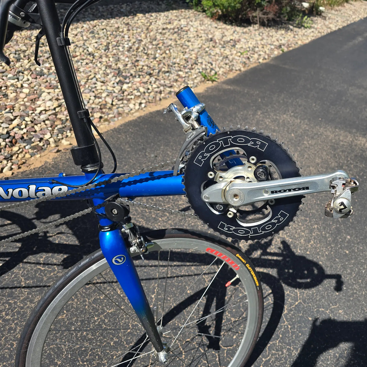 Closeup view of the Rotor Cranks on the Used Club Dual 650c Blue Small Recumbent Bike in an outdoor setting.