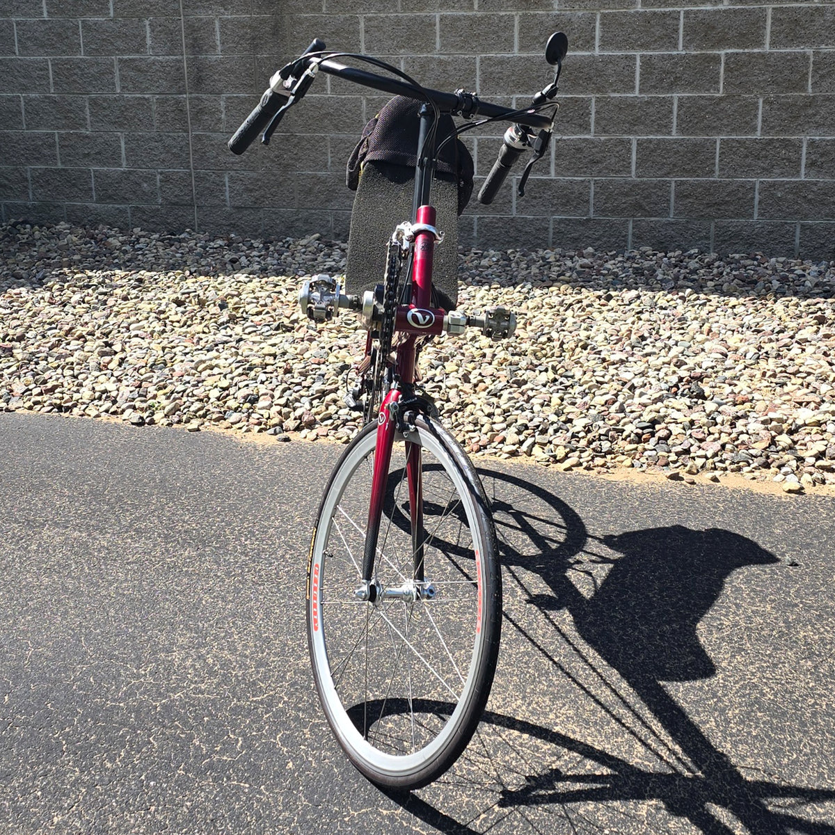 Front view of the Volae Used Club Dual 650c Red Large Recumbent Bike in an outdoor setting.