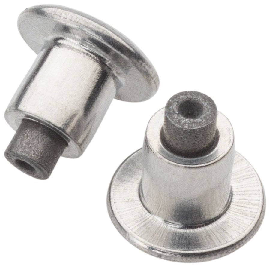 Studio image of a pair of silver tire studs.