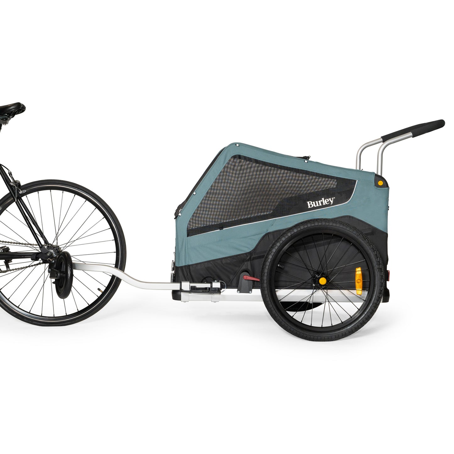 Side view of the Burley Bark Ranger XL Pet Trailer, shown connected to a bicycle, on a white background.