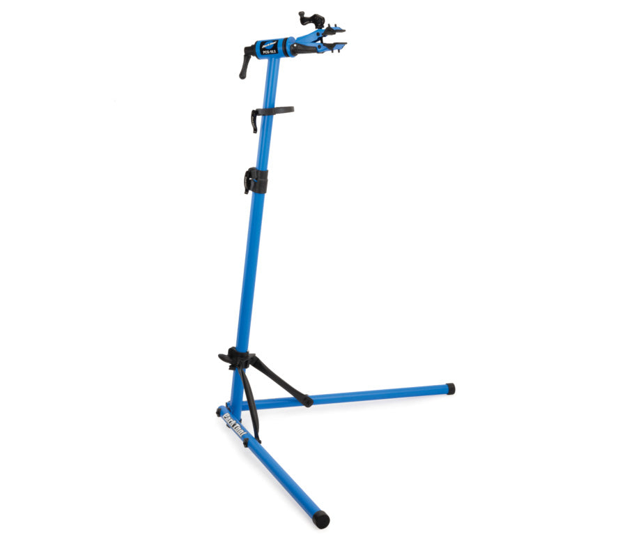 Studio image of Park Tool repair stand fully assembled with legs extended and clamp on. 