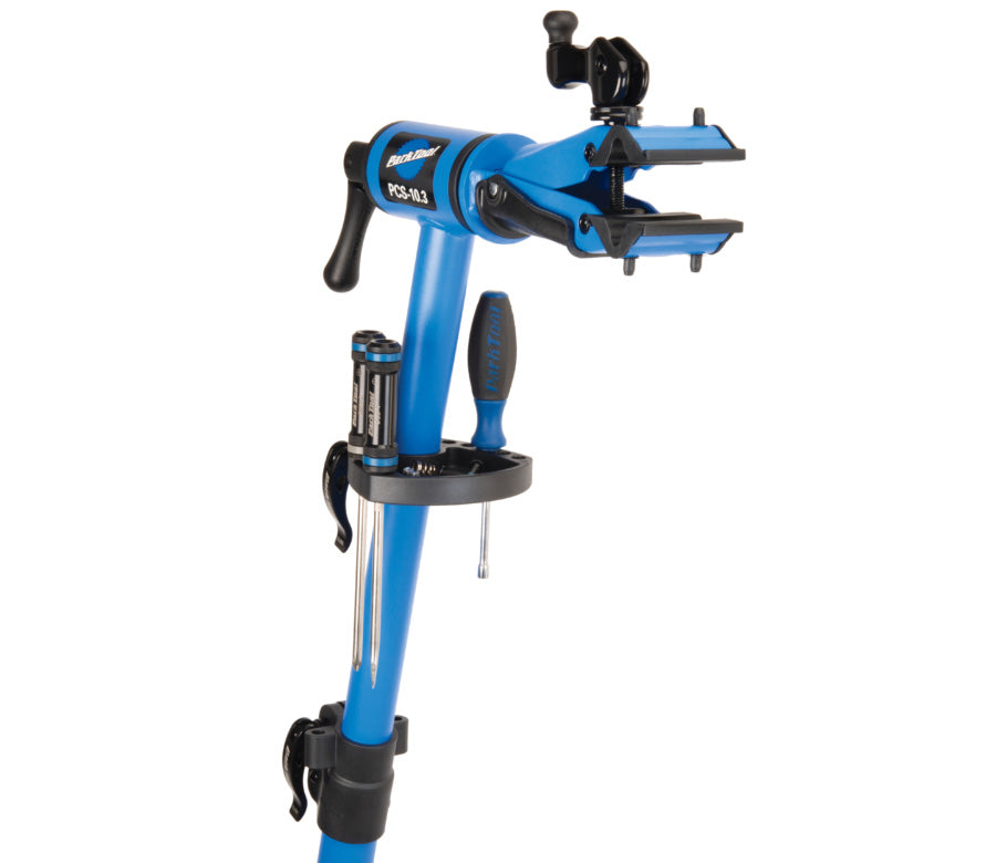 Close up studio image of the blue and black clamp and tool stand. 