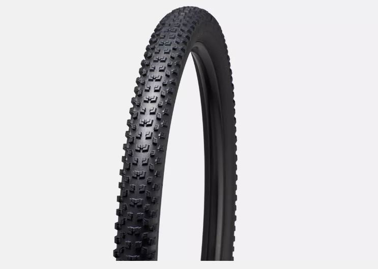 A black road bicycle tire with a herringbone tread pattern.